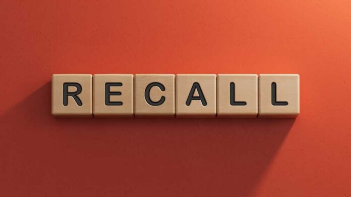 shutterstock_2564775647.jpg The word 'RECALL' displayed in wooden letter blocks against a red background