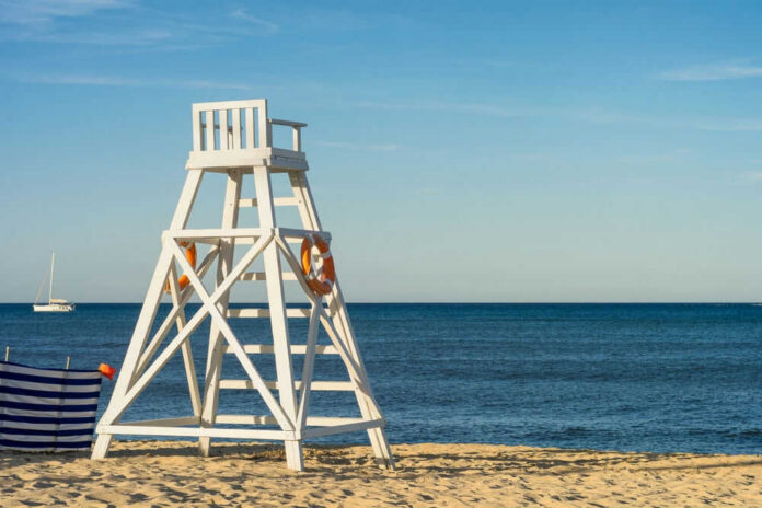 shutterstock2250156417jpg Lifeguard chair on sandy beach near ocean