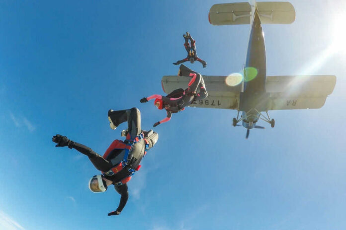 Skydivers jumping from an airplane in midair