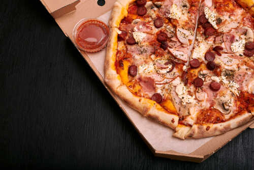 Pizza,In,A,Paper,Box,,Delivery,Concept A pizza with various toppings in a delivery box