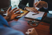 Handcuffs and documents on a desk during discussion.