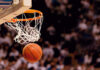 Basketball about to enter hoop during game