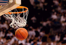 Basketball about to enter hoop during game