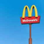 McDonald’s Doubles Down — Details! McDonald's restaurant sign against a clear blue sky