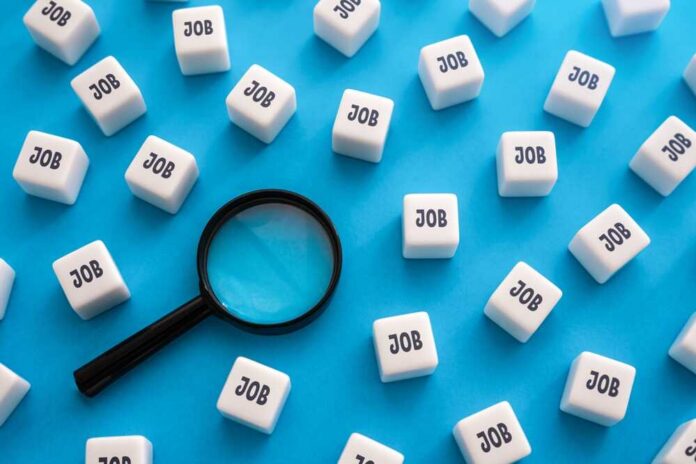 Search,For,Job,Openings,And,Vacancies.,Best,Offers,On,The Magnifying glass among cubes labeled job on blue background