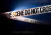 5 Murdered: Teenage Bloodbath Stuns Nation Police tape reading 'CRIME SCENE DO NOT CROSS' in a dark setting