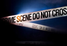 5 Murdered: Teenage Bloodbath Stuns Nation Police tape reading 'CRIME SCENE DO NOT CROSS' in a dark setting