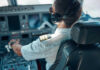 Hero Pilot’s Heartbreaking Turn Revealed Pilot in cockpit wearing headphones and operating aircraft controls