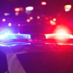 Florida Car, One Shot, Lifelong Fallout Police car with flashing red and blue lights at night
