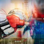 Gas Shock: War Hits Pumps at Home – AGAIN! Gas pump with financial data overlay and oil refinery in the background