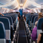 Mystery Fumes Hit Airline Crew Mid-Flight Airplane interior with passengers seated mid-flight.