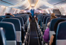 Mystery Fumes Hit Airline Crew Mid-Flight Airplane interior with passengers seated mid-flight.
