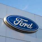 Mustangs Lose Power — Water Did This? Ford logo on a buildings exterior wall