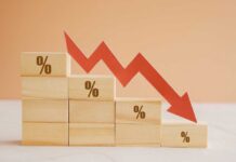 Prices DROP Hard — What’s Hiding? Wooden blocks with percentage symbols and a downward arrow indicating decline