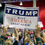 Trump’s Bold Midterm Gambit Large crowd holding Trump Make America Great Again sign.