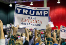 Trump’s Bold Midterm Gambit Large crowd holding Trump Make America Great Again sign.