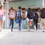 Pepper-Spray Drones Now Patrol School Halls? Children running with backpacks outside a school building.