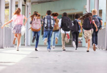 Pepper-Spray Drones Now Patrol School Halls? Children running with backpacks outside a school building.