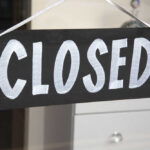 Iconic Candy Giant Abandons New Jersey A black sign with the word 'CLOSED' painted in white letters