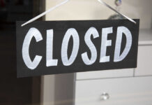 Iconic Candy Giant Abandons New Jersey A black sign with the word 'CLOSED' painted in white letters