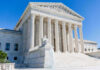 Roberts Overrules Halt — Drama Just Began Supreme Court building with columns, fountain, and statue.
