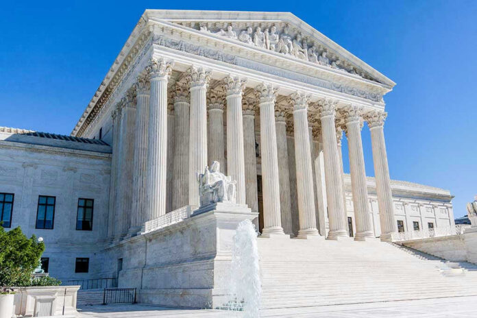 1118403221 Supreme Court building with columns, fountain, and statue.