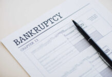 Delinquencies Spike To 15-Year High Bankruptcy Chapter 13 form with a pen resting on it