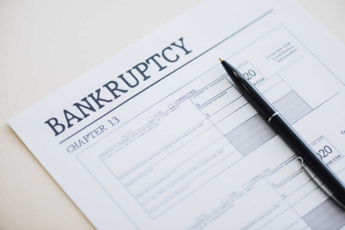 High,Angle,View,Of,Pen,On,Document,With,Bankruptcy,And Bankruptcy Chapter 13 form with a pen resting on it