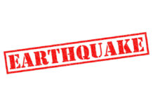 Star Power Takes Aim At Quake Disaster Red stamp with the word EARTHQUAKE