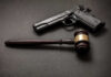 CEO Gunned Down — Stalker’s Chilling Court Admission Pistol and judge's gavel on dark surface
