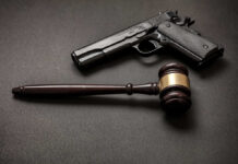 CEO Gunned Down — Stalker’s Chilling Court Admission Pistol and judge's gavel on dark surface