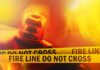 Arson Twist Explodes Wildfire Chaos Firefighter spraying water on a raging forest fire at night