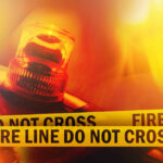 Arson Twist Explodes Wildfire Chaos Firefighter spraying water on a raging forest fire at night
