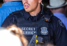 Secret Service officer in uniform with equipment visible.