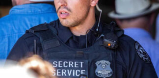 Secret Service officer in uniform with equipment visible.