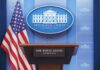 Sudden Exit From The Podium White House press briefing podium with microphones and U.S. flag