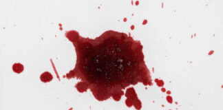 Red liquid splatter on a white background.