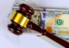 Green Bank Showdown Shocks Washington Judge’s gavel on a stack of U.S. hundred-dollar bills