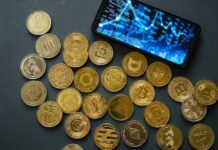 Bitcoin Vaults Cracked — Millions Vanish Various cryptocurrency coins scattered around a smartphone displaying market data