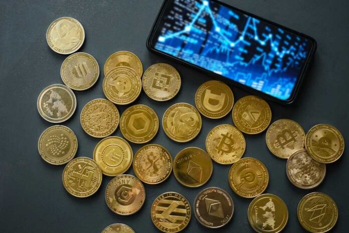 Various,Cryptocurrency,Coins,Lay,Scattered,On,A,Dark,Table.,A Various cryptocurrency coins scattered around a smartphone displaying market data