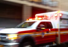 Laundry Room Bear Attack Ambulance with flashing lights speeding through a city street