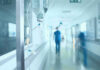 Fastest Ebola Outbreak Ever Hospital corridor with IV drip and healthcare worker.