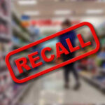 Target Sandals Recalled — Tiny Pearls, Big Danger Recall stamp on blurred store aisle background.