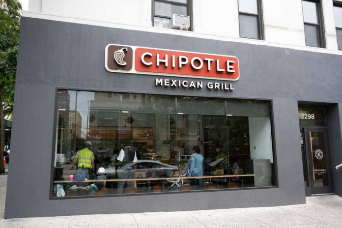 Chipotle Mexican Grill restaurant exterior with people inside.
