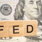 Fed Jacks Rates – Wallets Squeal Wooden blocks spelling 'FED' in front of a hundred dollar bill