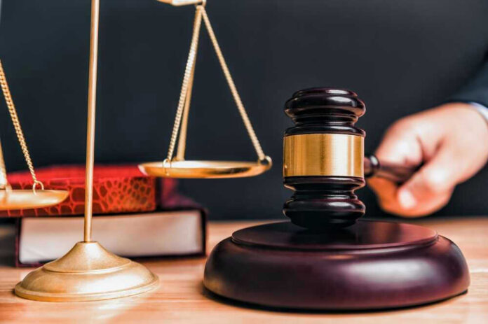 shutterstock_2314599993 Judge gavel, scales of justice, and law books.