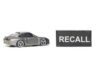 Blackout Recall Slams U.S. Automaker A miniature gray sports car next to a black sign that reads 'RECALL'