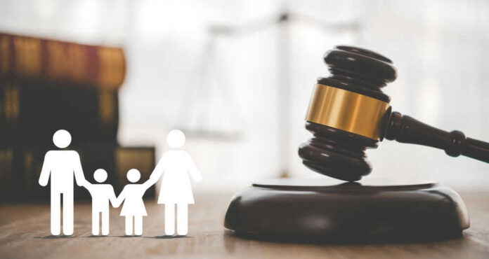 shutterstock_2509112733 Gavel with family symbols and legal book background.