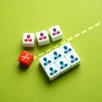 Massive Purge: Stars On The Chopping Block Colorful dice representing business roles and a scissors icon on a green background