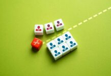 Colorful dice representing business roles and a scissors icon on a green background